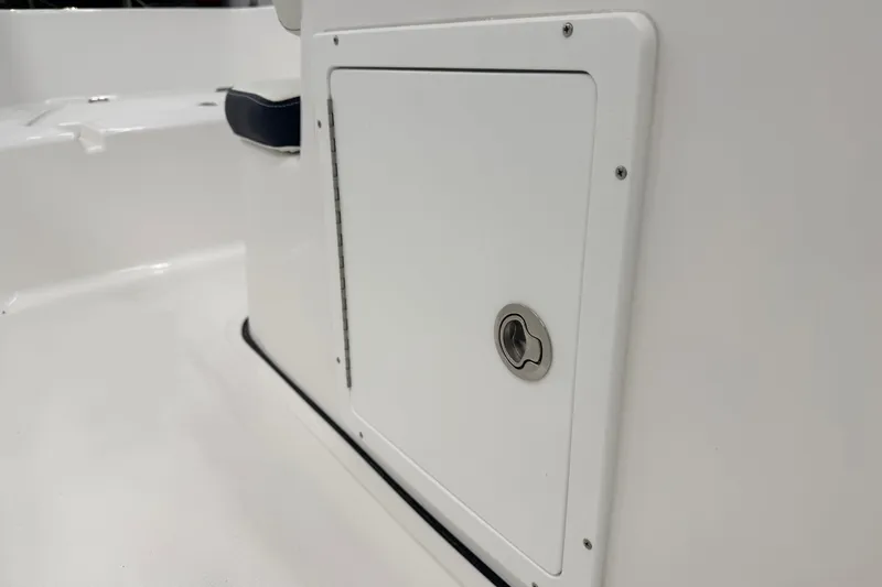 Slide: The Image of 2026 Tidewater 180 CC Adventure boat interior detail with storage compartment and rod holders. - 16