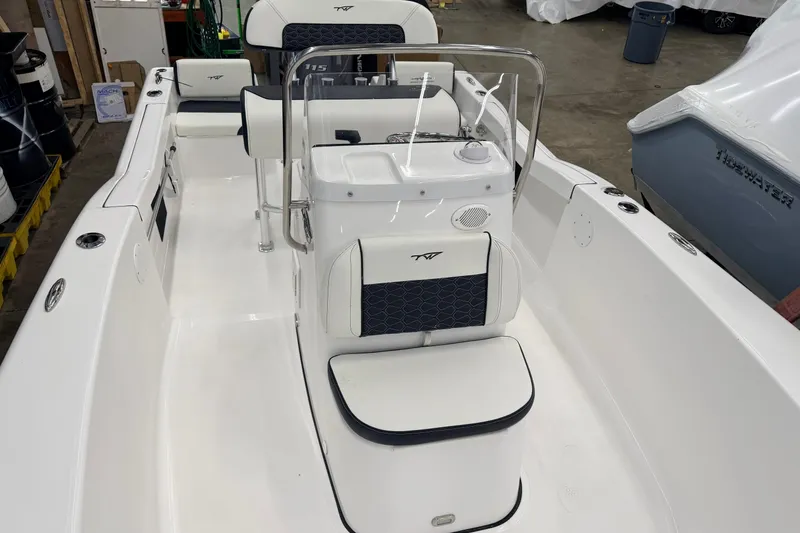 Slide: The Image of 2026 Tidewater 180 CC Adventure boat interior with seating and console, in a workshop setting. - 4