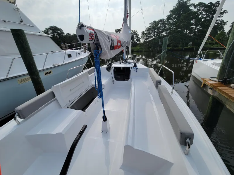 Slide: The Image of 2024 Zonda Z24 Base Model sailboat docked, showcasing sleek deck design and rigging. - 11