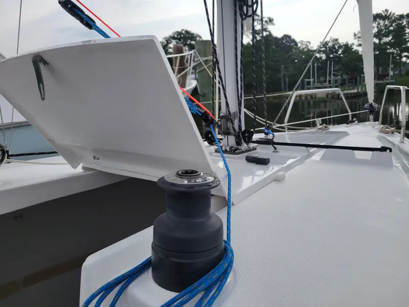 Slide: The Image of Sailboat deck with open hatch and winch, featuring blue ropes, Zonda Z24 Base Model 2024. - 16
