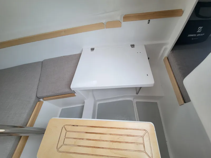 Slide: The Image of 2024 Zonda Z24 Base Model interior with foldable table and cushioned seating. - 20