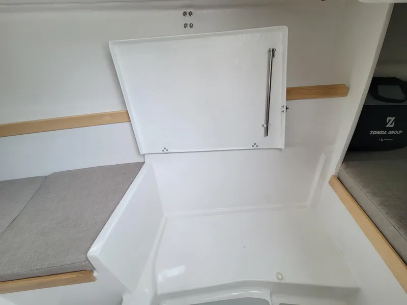 Slide: The Image of 2024 Zonda Z24 Base Model interior with storage compartment and cushioned seating. - 21