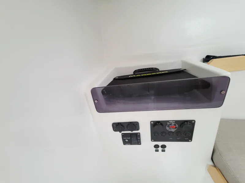 Slide: The Image of 2024 Zonda Z24 Base Model interior control panel with storage compartment. - 23