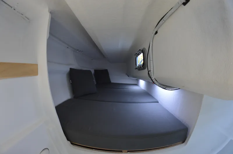 Slide: The Image of 2024 Zonda Z24 Base Model interior with compact sleeping area and cushions. - 24