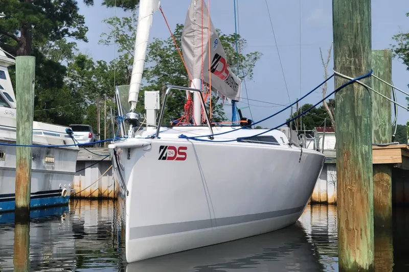 Slide: The Image of 2024 Zonda Z24 Base Model sailboat docked beside a larger yacht. - 3