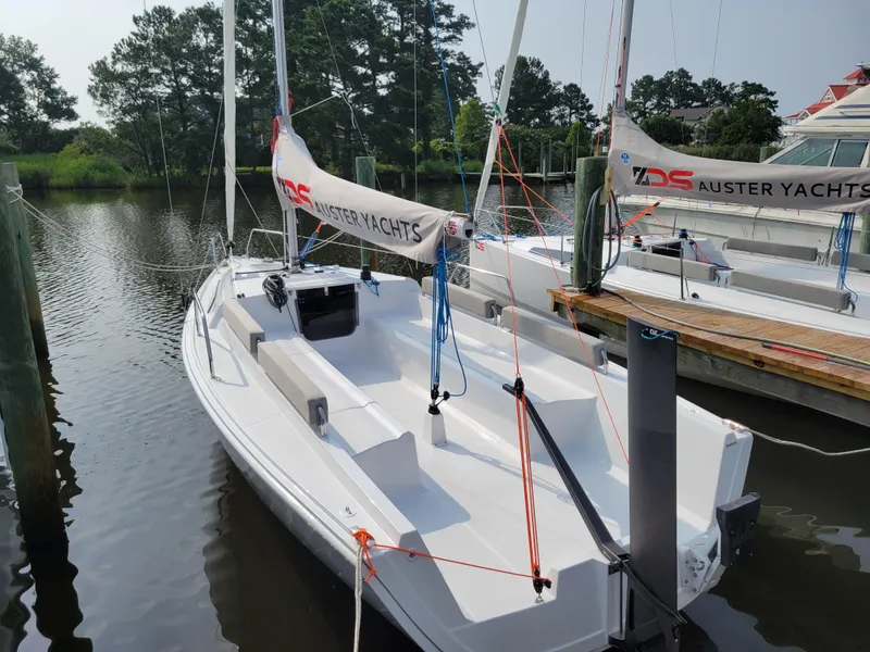 Slide: The Image of 2024 Zonda Z24 Base Model sailboat docked at a marina, featuring sleek design and modern rigging. - 6