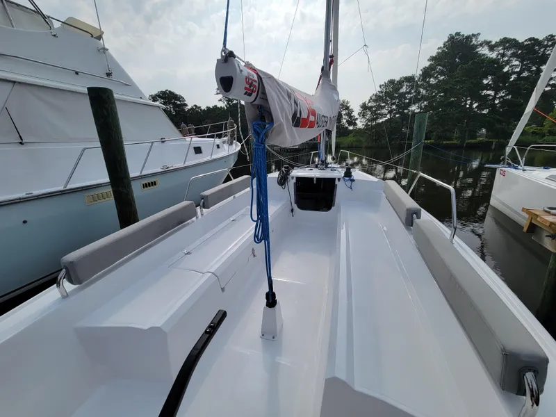 Slide: The Image of 2024 Zonda Z24 Base Model sailboat docked, showcasing sleek deck design and rigging. - 8