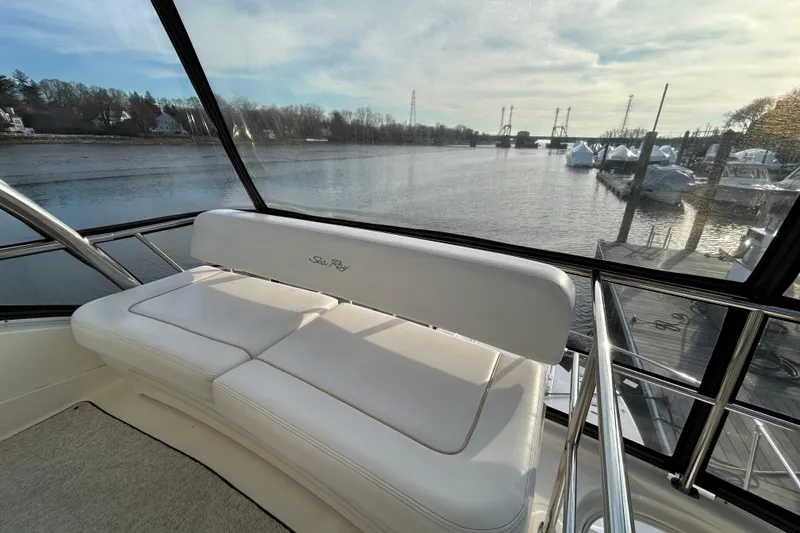 Slide: The Image of 2008 Sea Ray 52 Sedan Bridge interior with river view through large windows. - 10
