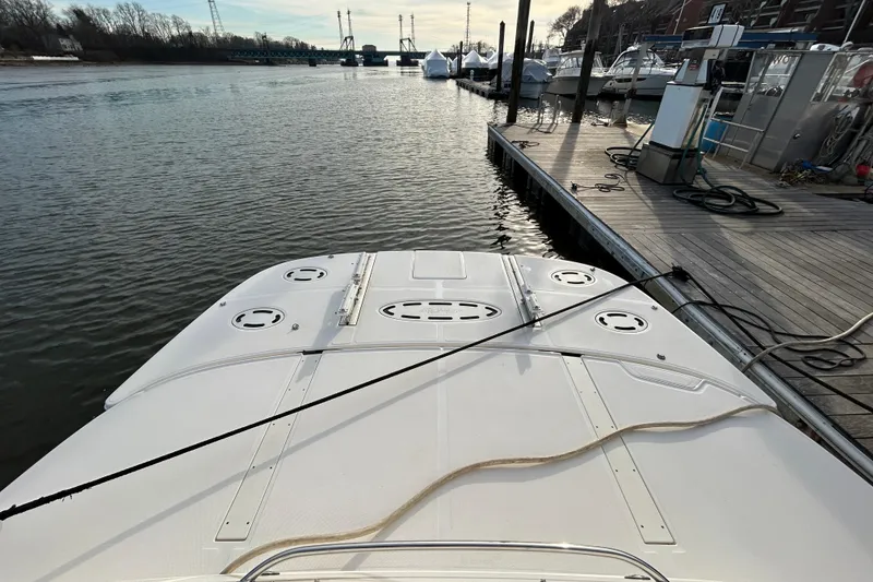 Slide: The Image of 2008 Sea Ray 52 Sedan Bridge docked at marina, calm water, clear sky. - 11
