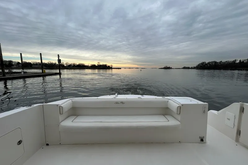Slide: The Image of 2008 Sea Ray 52 Sedan Bridge yacht at sunset, serene water view. - 12