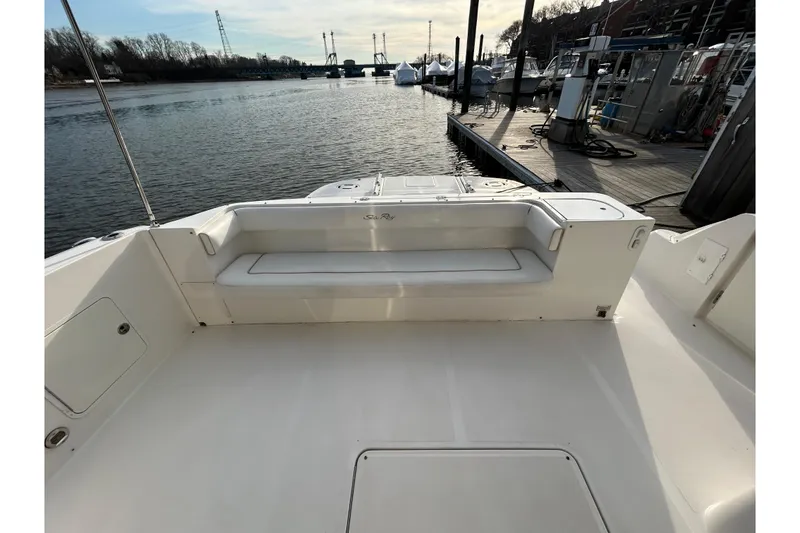 Slide: The Image of 2008 Sea Ray 52 Sedan Bridge yacht deck with seating, docked by the waterfront. - 13