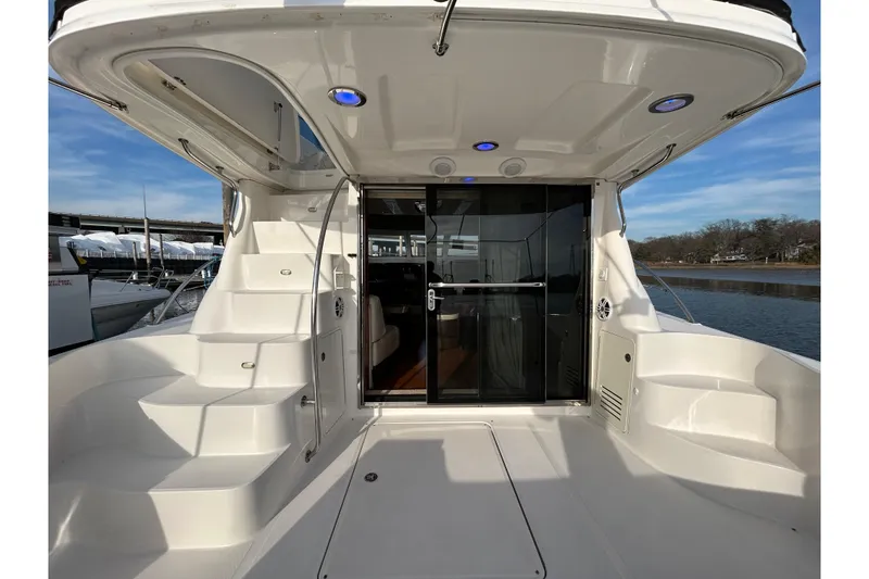 Slide: The Image of 2008 Sea Ray 52 Sedan Bridge yacht, rear deck view with stairs and glass doors. - 14