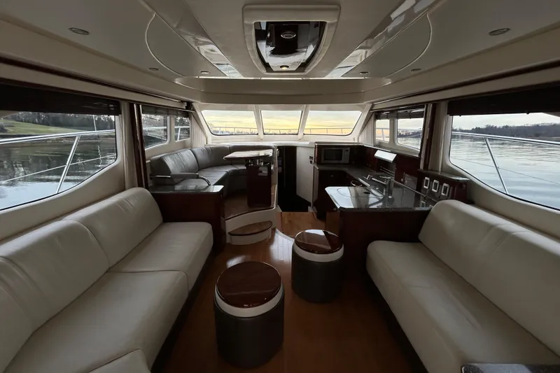 Slide: The Image of Luxurious interior of 2008 Sea Ray 52 Sedan Bridge yacht with elegant seating and panoramic windows. - 16