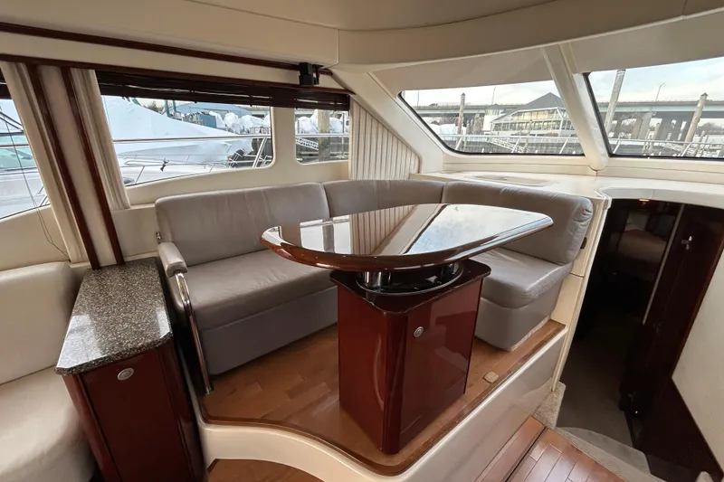 Slide: The Image of Luxurious interior of 2008 Sea Ray 52 Sedan Bridge yacht with elegant seating and table. - 19