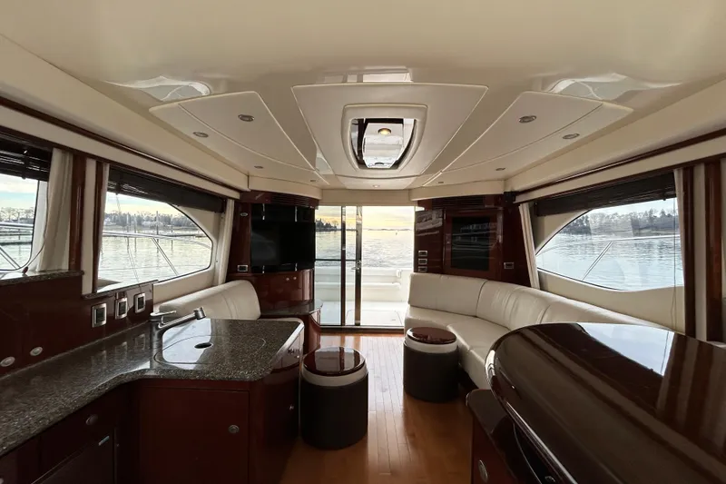 Slide: The Image of Luxurious interior of 2008 Sea Ray 52 Sedan Bridge yacht with elegant furnishings and panoramic windows. - 21