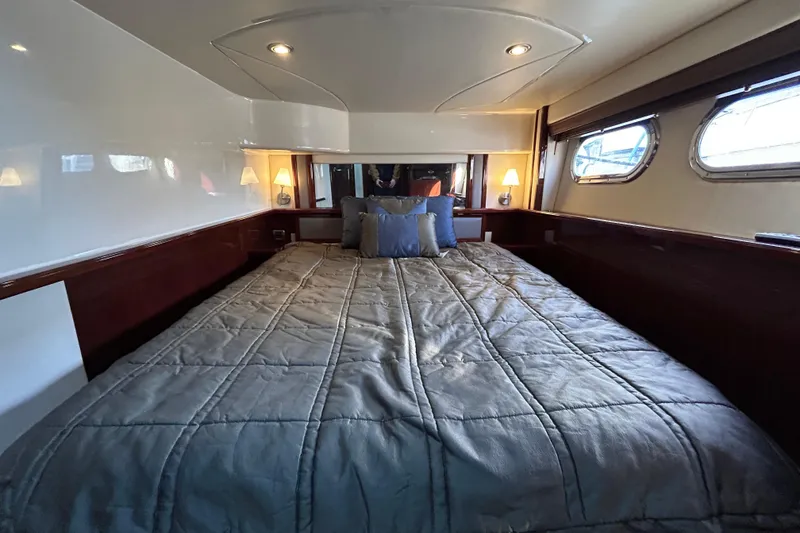 Slide: The Image of Luxurious bedroom interior of 2008 Sea Ray 52 Sedan Bridge yacht with cozy bedding. - 24