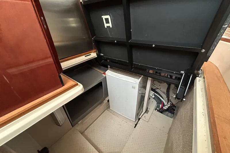 Slide: The Image of 2008 Sea Ray 52 Sedan Bridge interior with storage and small refrigerator. - 29