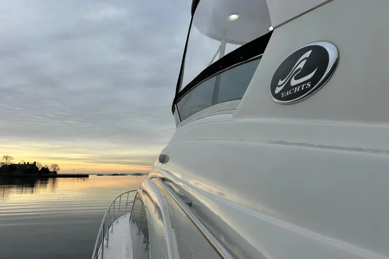 Slide: The Image of 2008 Sea Ray 52 Sedan Bridge yacht at sunset on calm waters. - 5