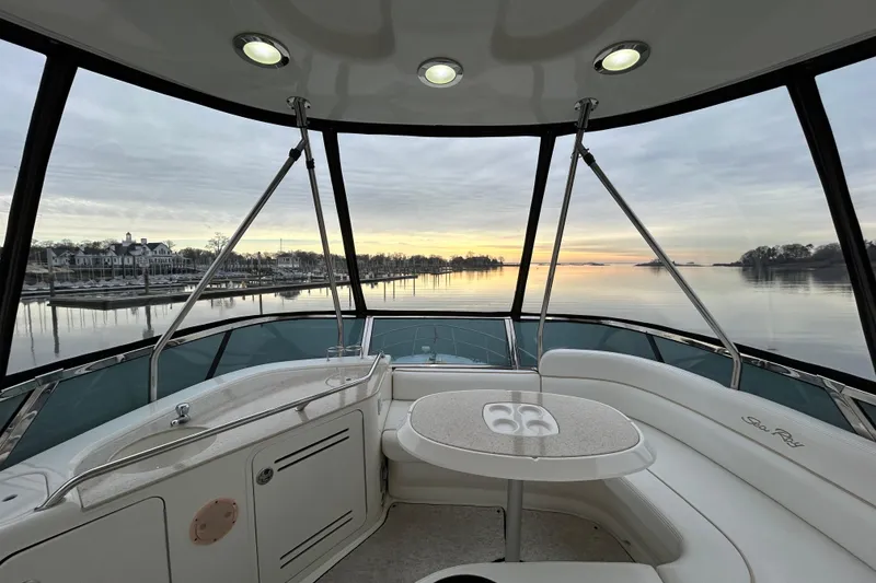Slide: The Image of 2008 Sea Ray 52 Sedan Bridge interior with serene waterfront view at sunset. - 8