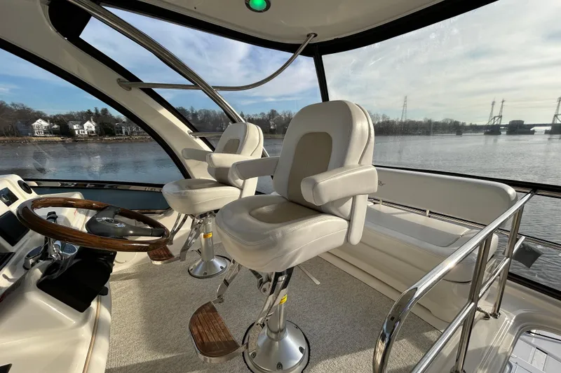 Slide: The Image of Interior of 2008 Sea Ray 52 Sedan Bridge yacht with helm and captain's chairs. - 9