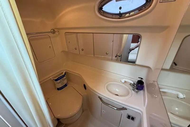 Slide: The Image of 2003 Sea Ray 320 Sundancer bathroom with sink, toilet, and mirror. - 21