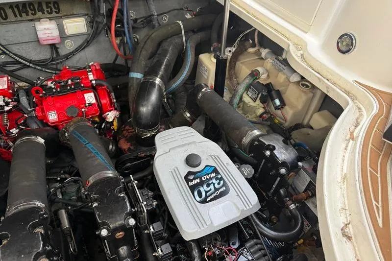 Slide: The Image of Engine compartment of a 2003 Sea Ray 320 Sundancer boat, featuring a 350 MAG MPI engine. - 26