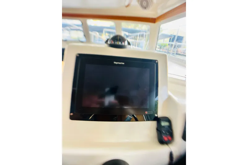 Slide: The Image of Control panel of a 2007 PDQ MV41 boat with navigation screen. - 12