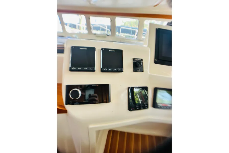 Slide: The Image of Control panel of a 2007 PDQ MV41 boat with navigation and audio systems. - 13