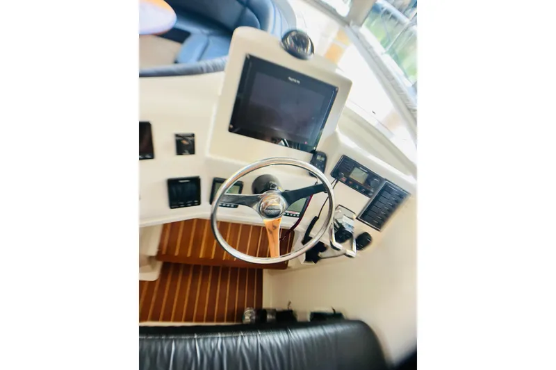 Slide: The Image of Steering console of a 2007 PDQ MV41 boat with navigation equipment. - 14