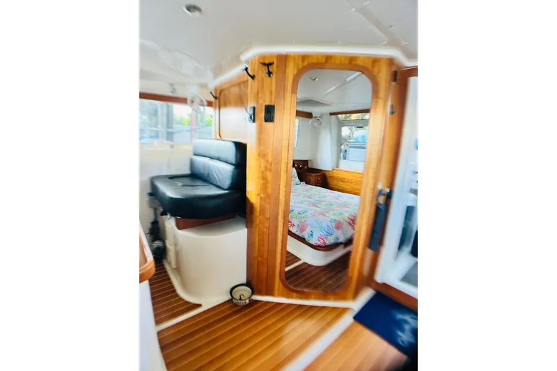 Slide: The Image of Interior of 2007 PDQ MV41 boat with wooden finish and cozy bedroom. - 15