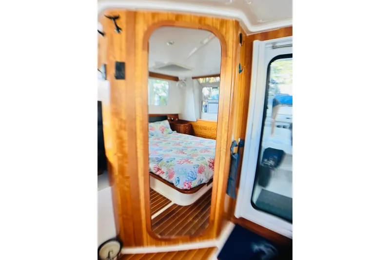 Slide: The Image of Cozy bedroom interior of 2007 PDQ MV41 boat with wooden accents and floral bedding. - 17