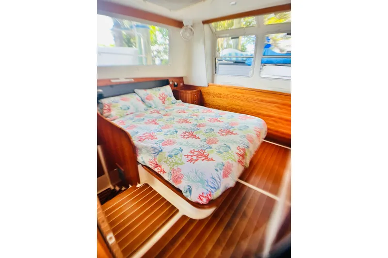 Slide: The Image of Cozy bedroom in 2007 PDQ MV41 boat with colorful bedding and wooden interior. - 18