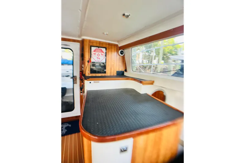 Slide: The Image of Interior of 2007 PDQ MV41 boat with wood accents and large window. - 19