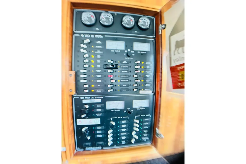 Slide: The Image of Electrical control panel on a 2007 PDQ MV41 boat, featuring gauges and switches. - 21