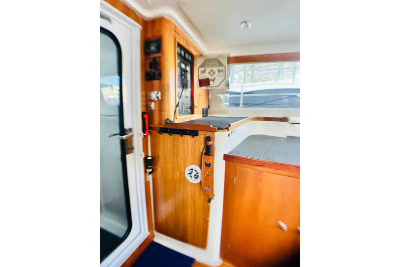 Slide: The Image of Interior of 2007 PDQ MV41 boat with wooden cabinetry and control panel. - 22