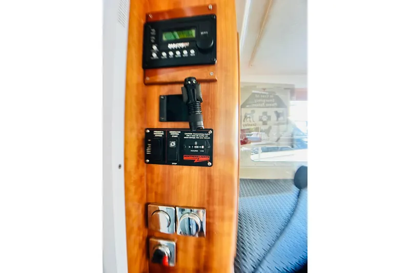 Slide: The Image of Control panel inside a 2007 PDQ MV41 boat, featuring various switches and displays. - 24