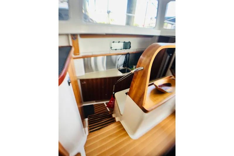 Slide: The Image of Interior view of 2007 PDQ MV41 boat with wooden stairs and cabinetry. - 25