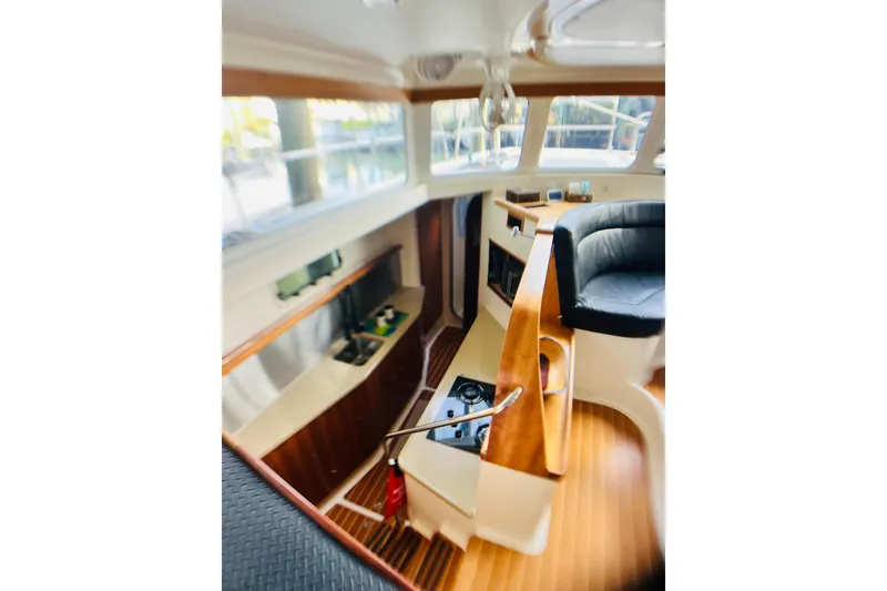 Slide: The Image of Interior of 2007 PDQ MV41 boat with wood accents and seating area. - 26