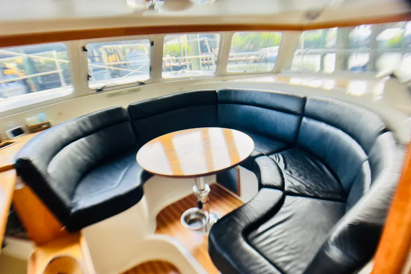 Slide: The Image of Luxurious interior of 2007 PDQ MV41 yacht with black leather seating and round table. - 28