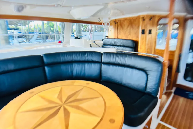 Slide: The Image of Luxurious interior of 2007 PDQ MV41 yacht with black seating and wooden table. - 30