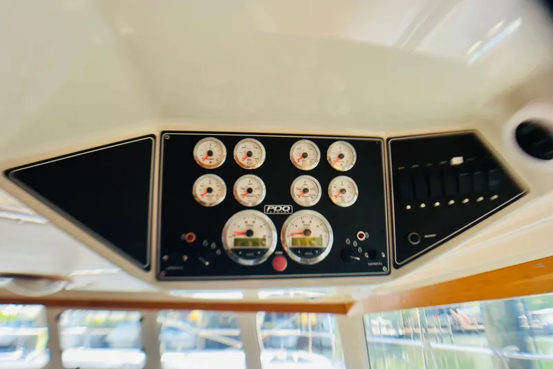 Slide: The Image of Dashboard of a 2007 PDQ MV41 boat with gauges and controls. - 33