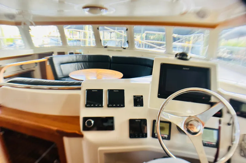 Slide: The Image of Interior of 2007 PDQ MV41 boat with steering wheel and seating area. - 35