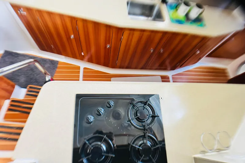 Slide: The Image of Interior of 2007 PDQ MV41 yacht kitchen with stove, sink, and wooden cabinets. - 37