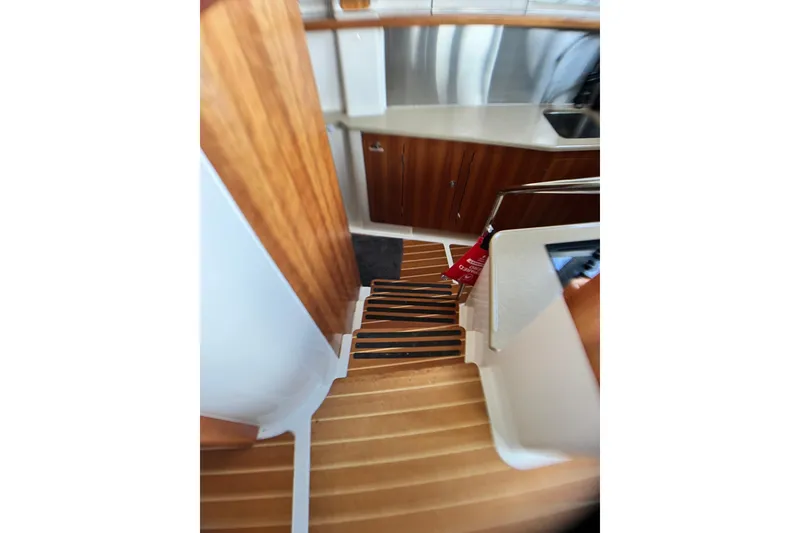Slide: The Image of Interior of 2007 PDQ MV41 boat with wooden stairs and kitchen area. - 38