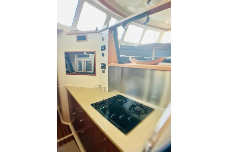 Slide: The Image of Interior of 2007 PDQ MV41 boat with modern kitchen and seating area. - 39