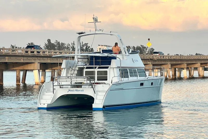 Slide: The Image of 2007 PDQ MV41 catamaran cruising near a bridge in Maui, Hawaii. - 4