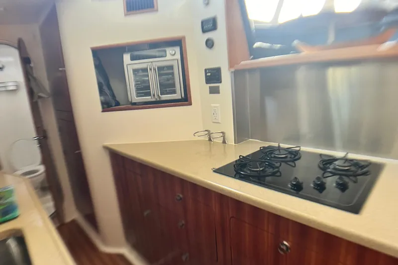 Slide: The Image of Compact kitchen in 2007 PDQ MV41 boat with stove and oven. - 40