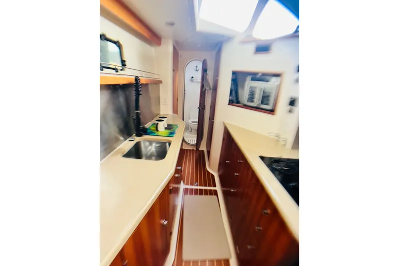 Slide: The Image of Interior of 2007 PDQ MV41 yacht kitchen with wooden cabinets and modern appliances. - 41