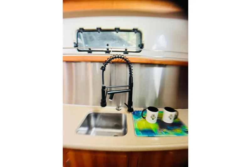 Slide: The Image of PDQ MV41 2007 kitchen sink with modern faucet and two mugs on counter. - 42