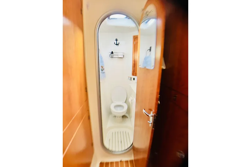 Slide: The Image of 2007 PDQ MV41 yacht bathroom with wooden door and nautical decor. - 43